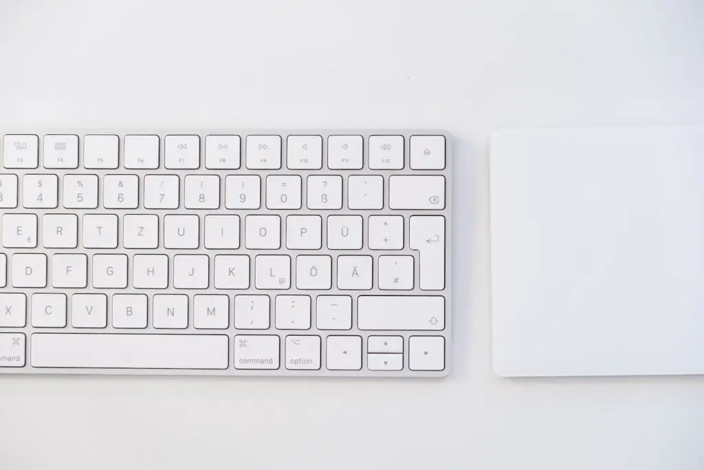 white apple keyboard on white table